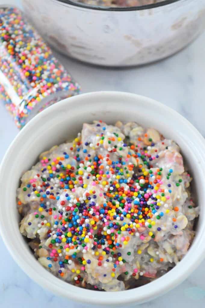 A white bowl filled with funfetti overnight oats.